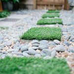 DIY faux grass stepping stones in a home garden