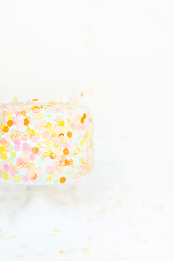 a sole photo of colorful cake with edible confetti toppings - party popper cake topper