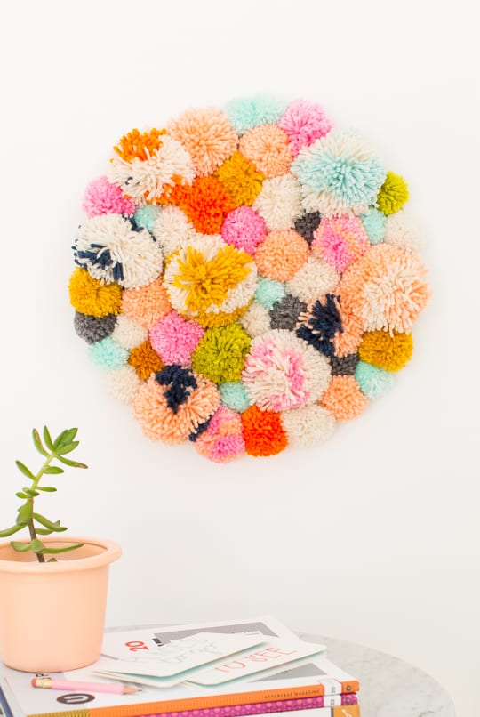 DIY Pom Pom Wall Hanging by Top Lifestyle Blogger Ashley Rose | Sugar & Cloth #DIY #pompom #wallhanging #yarn #yarnpompoms #homedecor #diydecor #colorful #make