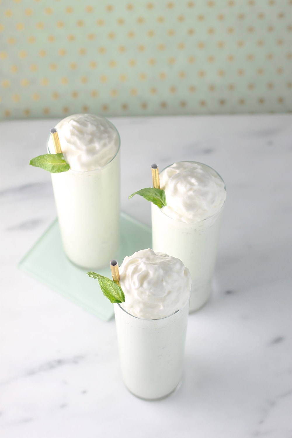 photo of boozy shamrock milkshakes with whipped cream