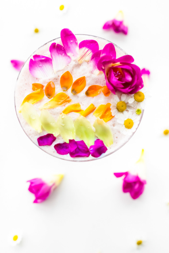 flowers for cocktails - top view of the cocktail with colorful petals