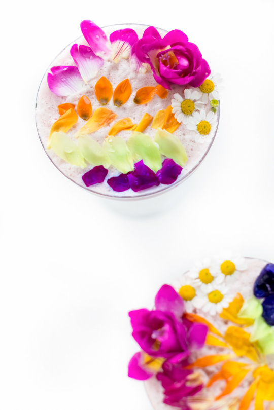 cocktail with perfectly colorful garnish - edible flowers in drinks