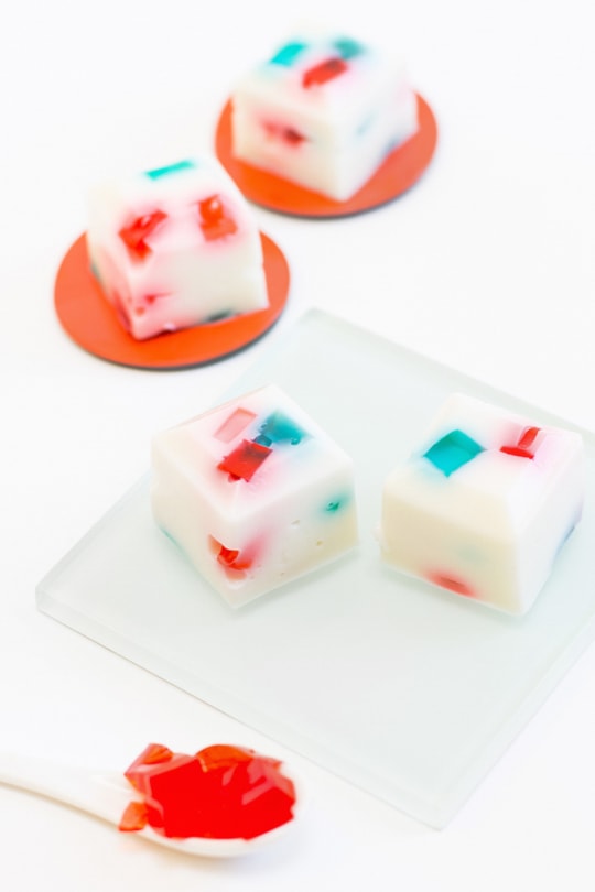 a photo of sliced Red White and Blue Jello Shots on a plate with red jello chunks