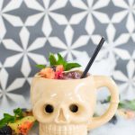 photo of the Halloween drink, the Shrunken Skull Cocktail recipe by top Houston lifestyle blogger Ashley Rose of Sugar & Cloth