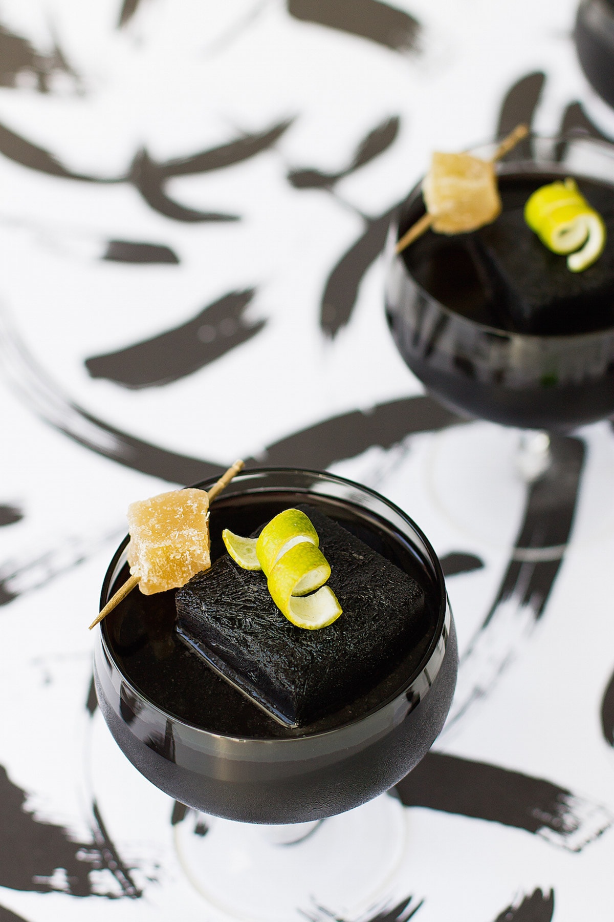 garnished with ginger and a lime - Detoxing Activated Charcoal Cocktail Recipe by top Houston Lifestyle Blogger Ashley Rose of Sugar and Cloth #recipe #cocktail #halloween #detox #charcoal 
