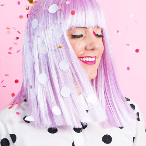 photo of a girl in a polka wig with confetti by sugar and cloth