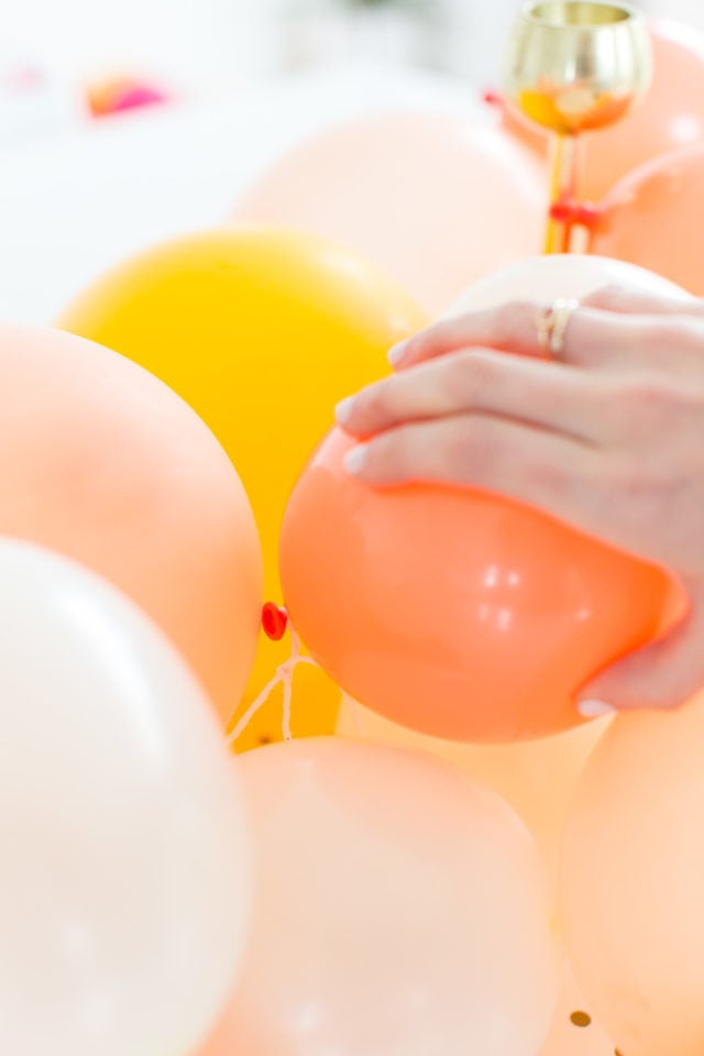 arranging a latex balloon on the balloon centerpieces