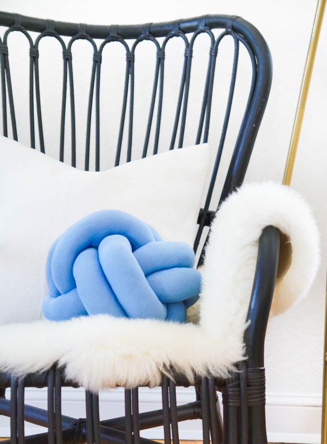 DIY knot pillow on a black chair
