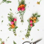 a photo of 3 sage bundles with flowers and scissors