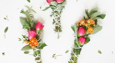 a photo of 3 sage bundles with flowers and scissors