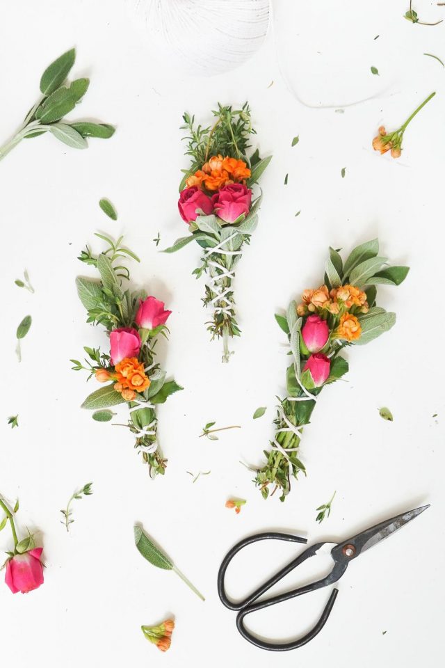 a photo of 3 sage bundles with flowers and scissors