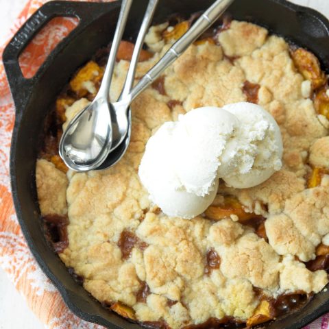 Skillet Peach Cobbler Recipe served with vanilla ice cream by Ashley Rose of Sugar & Cloth, a top lifestyle blog in Houston, Texas