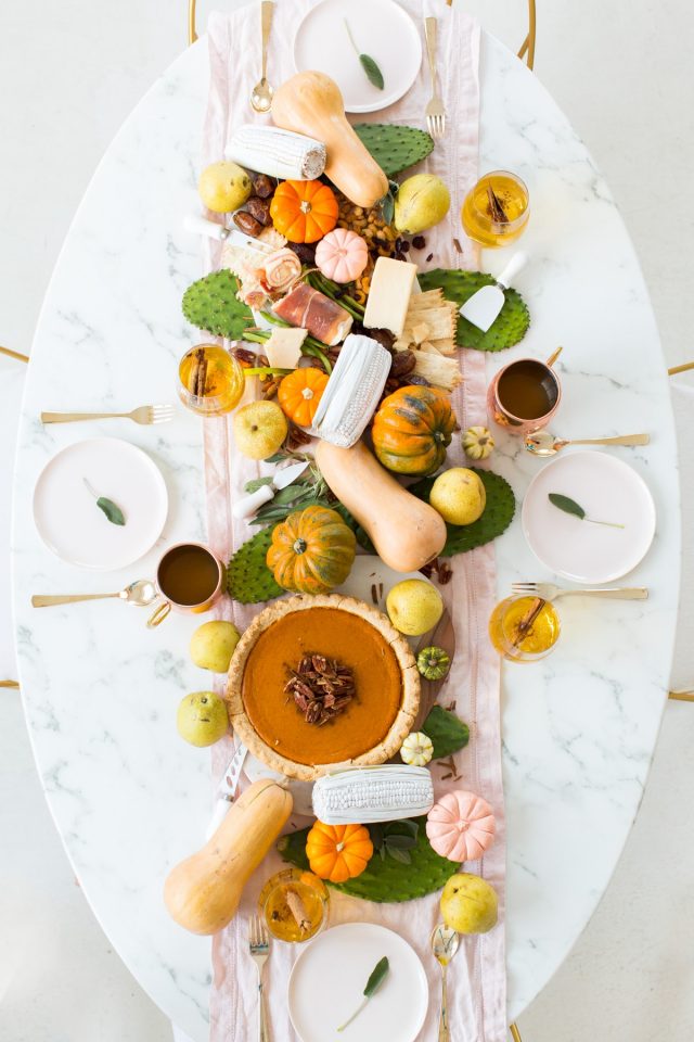 overhead photo of a styled thanksgiving table centerpiece decor with gourds by sugar and cloth