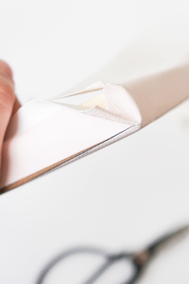 photo of how to fold the corners of your canvas art by top Houston lifestyle blogger Ashley Rose of Sugar & Cloth