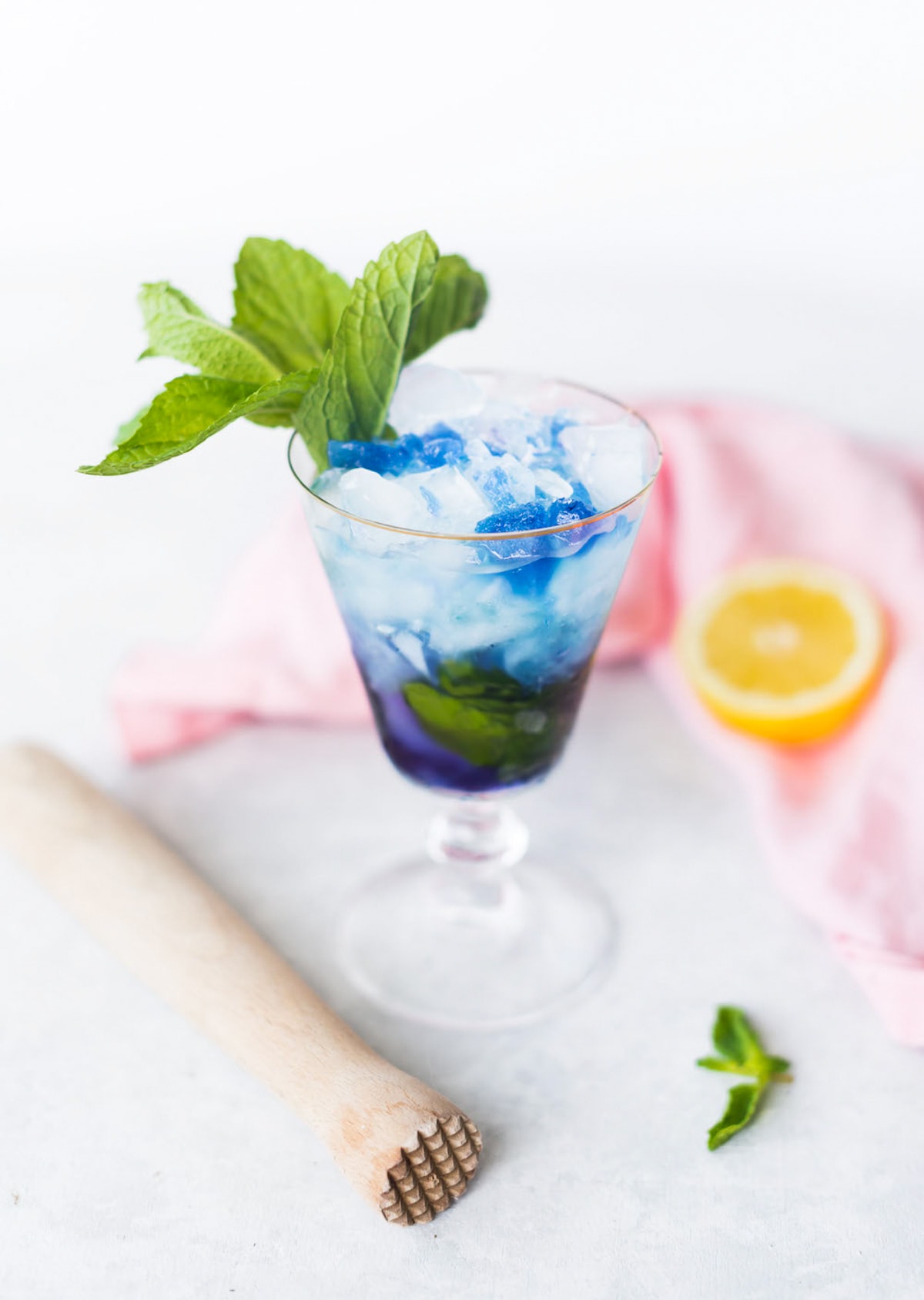 photo of the Butterfly Pea Flower Tea Cocktail before it changes colors by top Houston lifestyle blogger Ashley Rose of Sugar & Cloth