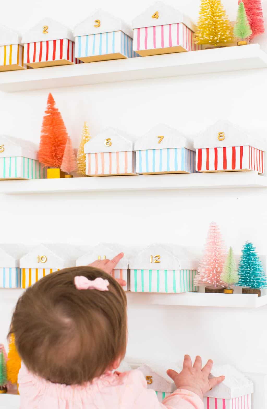 Gwen loves the colorful boxes advent calendar - Colorful Houses DIY Advent Calendar by top Houston lifesyle blogger Ashley Rose of Sugar and Cloth #diy #christmas #advent #holiday #decor #idea #howto #kids #crafts