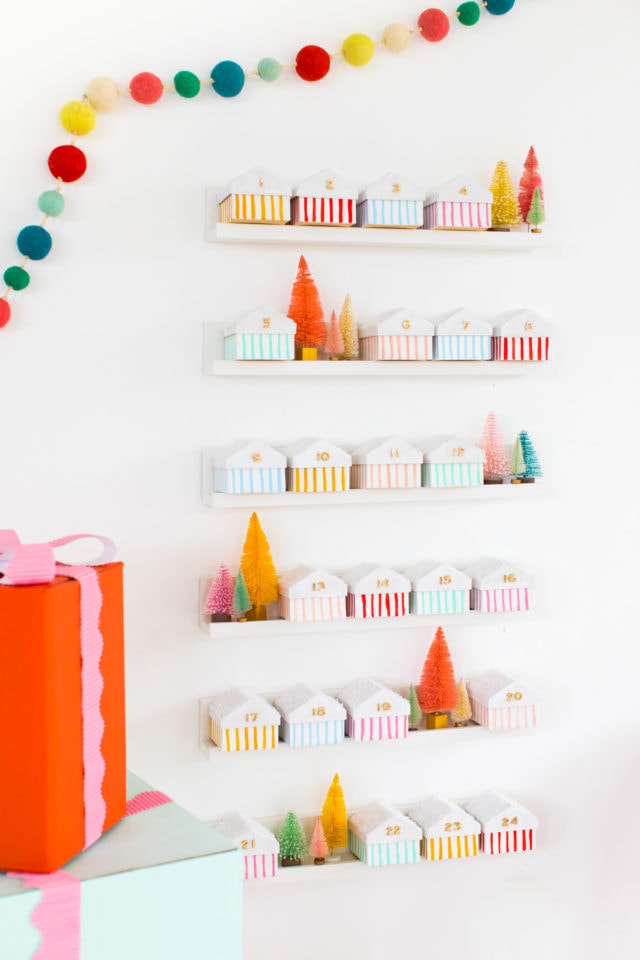 Christmas houses on temporary floating shelves - Colorful Houses DIY Advent Calendar by top Houston lifesyle blogger Ashley Rose of Sugar and Cloth #diy #christmas #advent #holiday #decor #idea #howto #kids #crafts