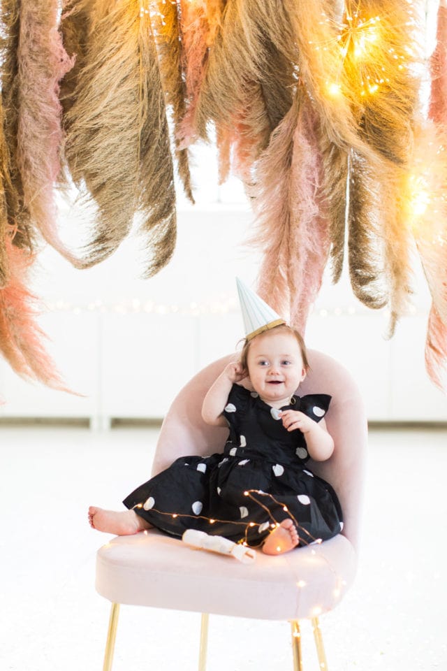 gwen in her cute little party hat! Sharing photos via Live Albums and google hub! Pampas Grass DIY Photo Backdrop by top Houston lifestyle blogger Ashley Rose of Sugar & Cloth #diy #nye #backdrop #photography #photos #google #holidays #howto #weddings #parties #entertaining 