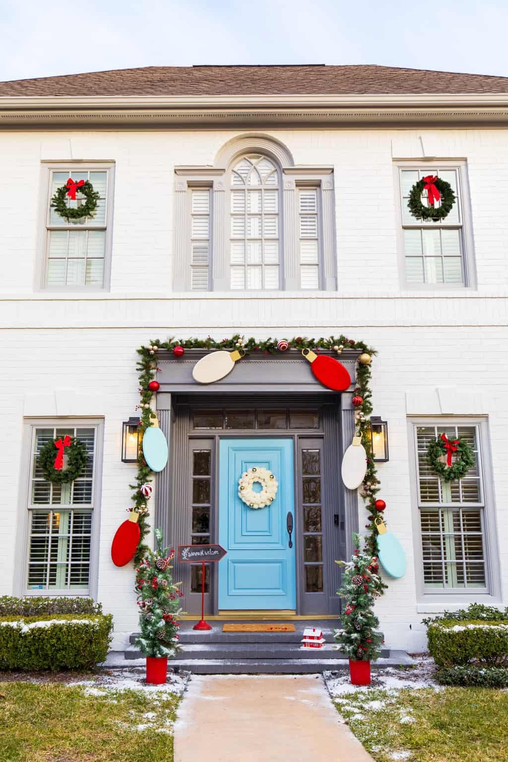 photo of a house with front door decor for christmas