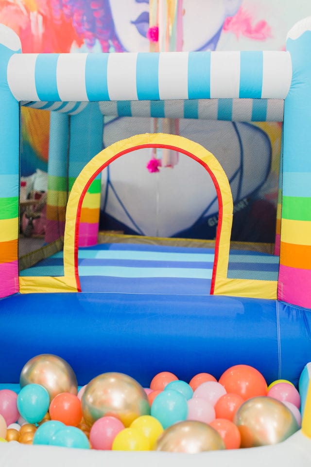 rainbow bounce house for a first birthday party by Sugar & Cloth
