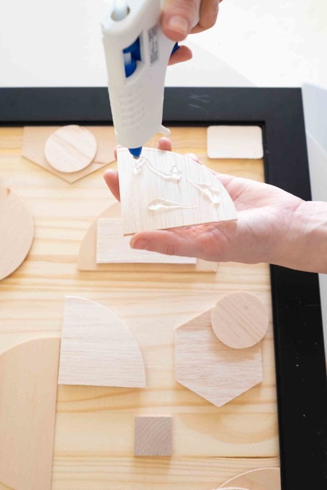 This DIY abstract wood artwork is SUPER simple to make, but it packs a big punch on how expensive it looks! Plus I'm teaching you how to cut wood easily into shapes with Cricut! by top Houston Lifestyle blogger Ashley Rose of Sugar & Cloth #design #diy #wood #art #decor #interiors