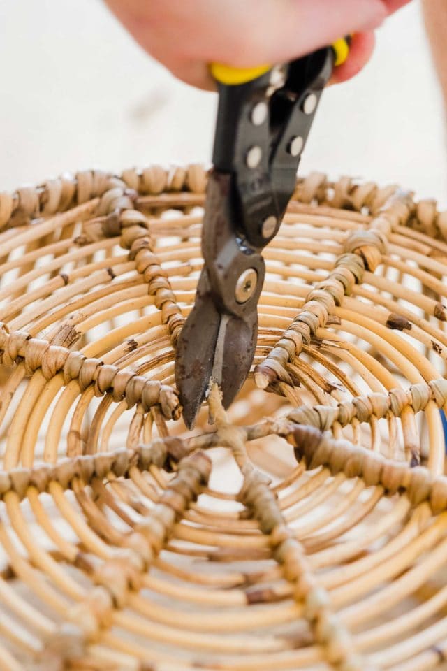 picture of how to cut the bottom center of a basket for the DIY basket light by Sugar & Cloth