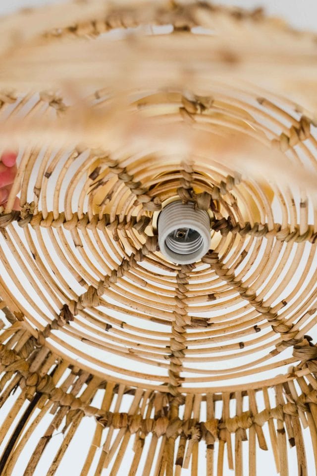 a picture of how to attach the DIY basket light to the light fixture on the ceiling by Sugar & Cloth