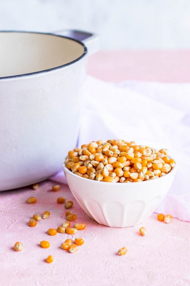 photo of unpopped popcorn kernels by sugar and cloth