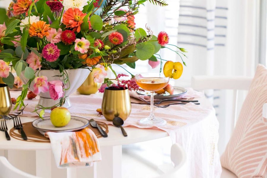 photo of the corner of a decorated fall dining table by sugar and cloth in houston