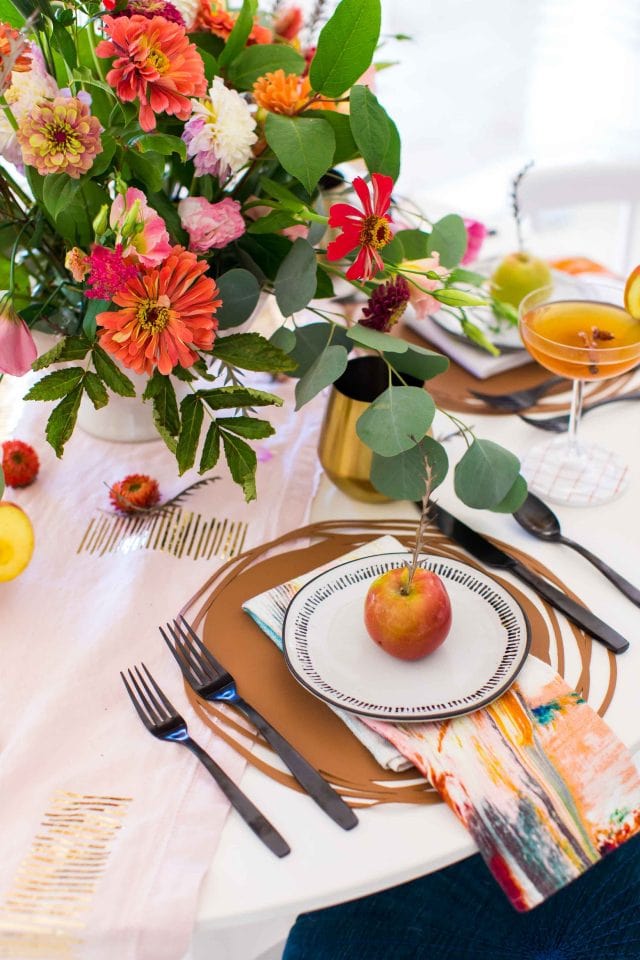 picture of a fall flower arrangement at a place setting by sugar and cloth