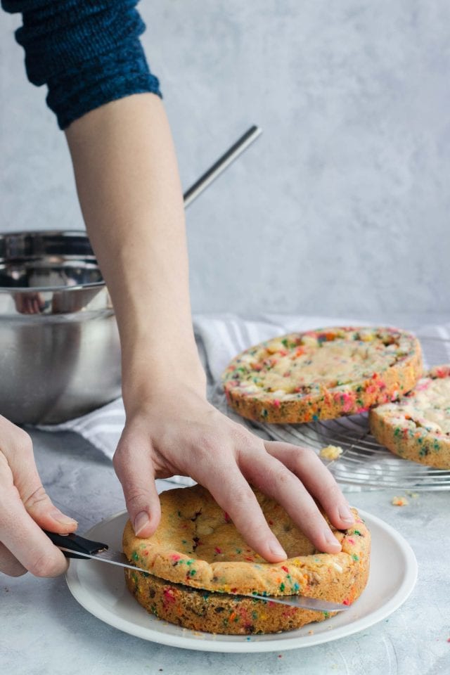 a photo of preparing the layers to a Funfetti Sugar Cookie Cake, recipe by top Houston lifestyle blogger Ashley Rose of Sugar & Cloth