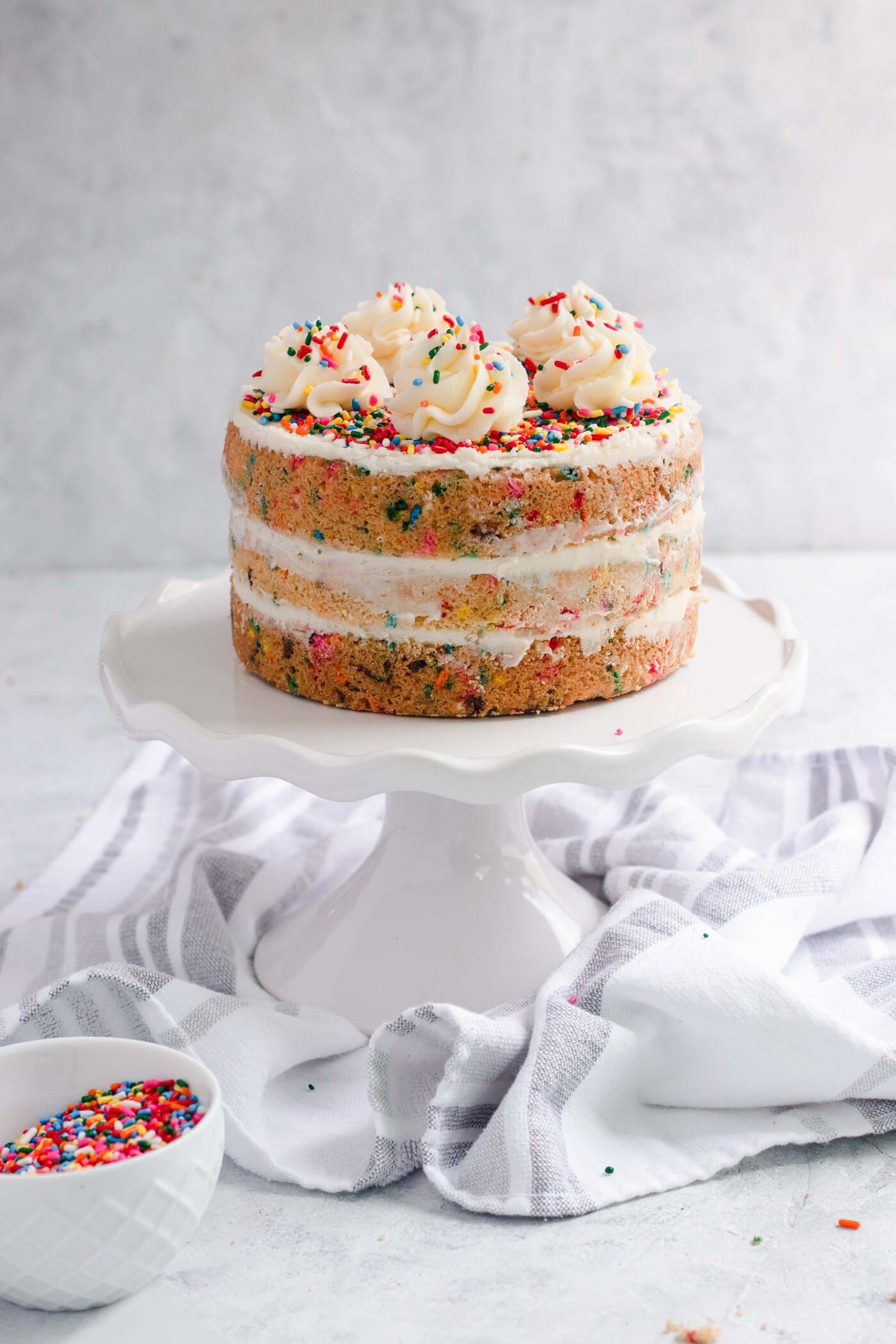 photo Funfetti Sugar Cookie Cake on cake stand by top Houston lifestyle blogger Ashley Rose of Sugar & Cloth