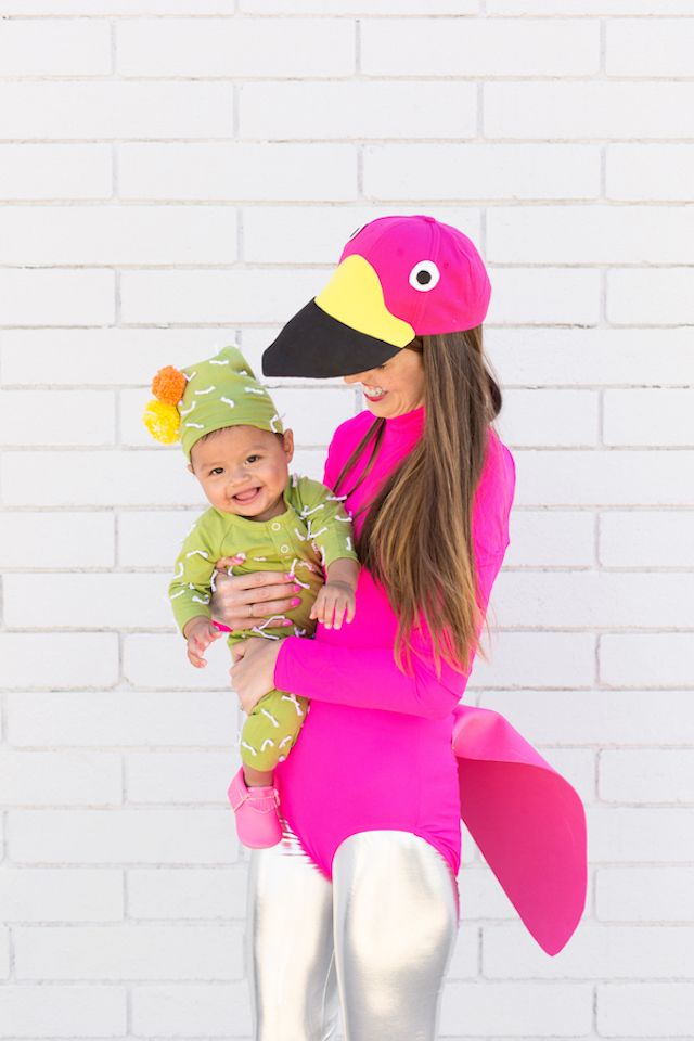 Photo of mom in lawn flamingo costume and holding baby in cactus costume