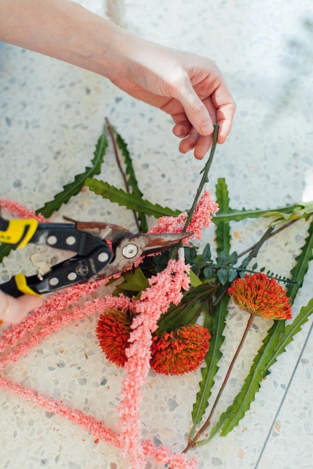 photo of a girl cutting fake flowers