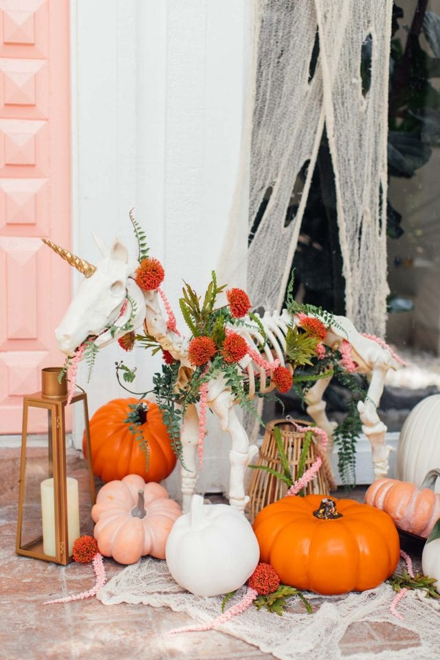 photo of a pink door with halloween door decor