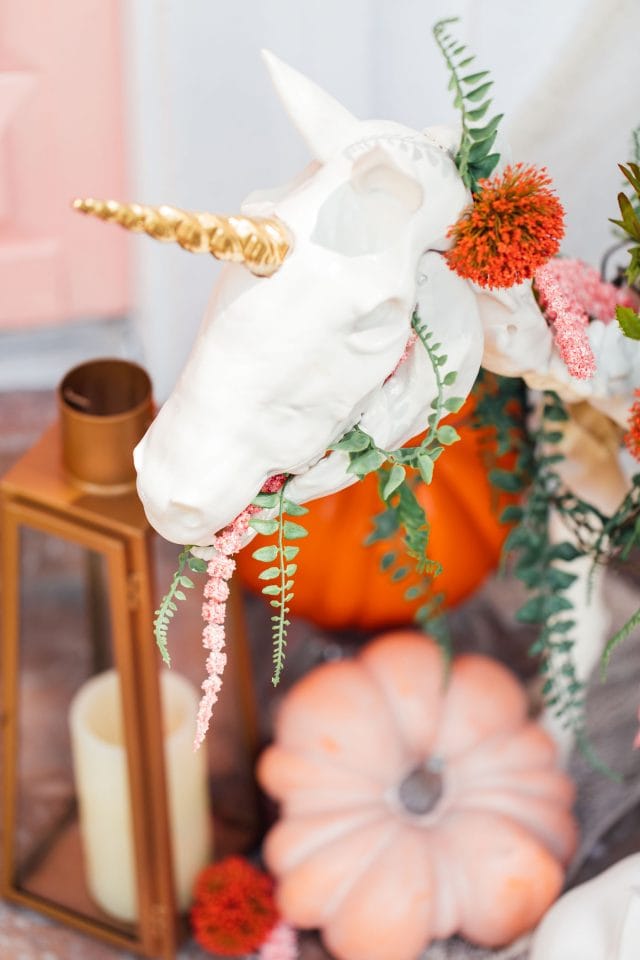 close up photo of a gold unicorn skeleton outdoor halloween decoration