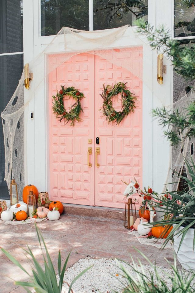 photo of a pink door with halloween decorations