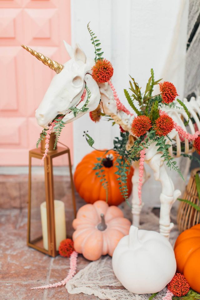 photo of a unicorn skeleton and halloween front door decor