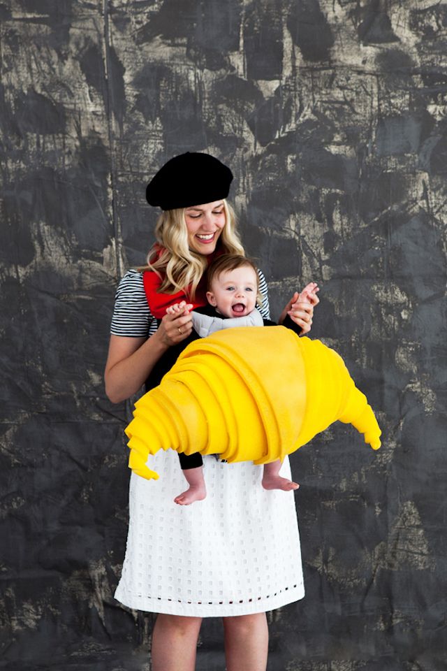 Photo of mom dressed as French woman holding baby in DIY croissant costume