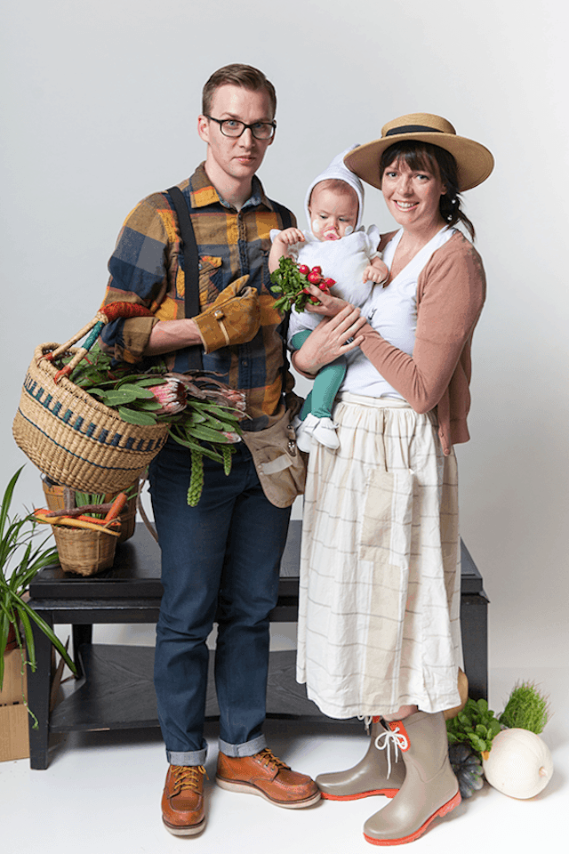 Photo of parents in gardener costumes holding baby in garlic costume