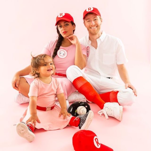 Photo of parents and child in League of Their Own Halloween costumes