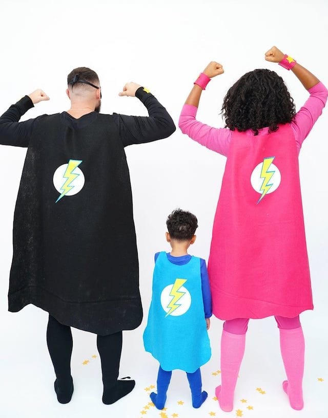 Photo of parents and child in DIY superhero halloween costumes