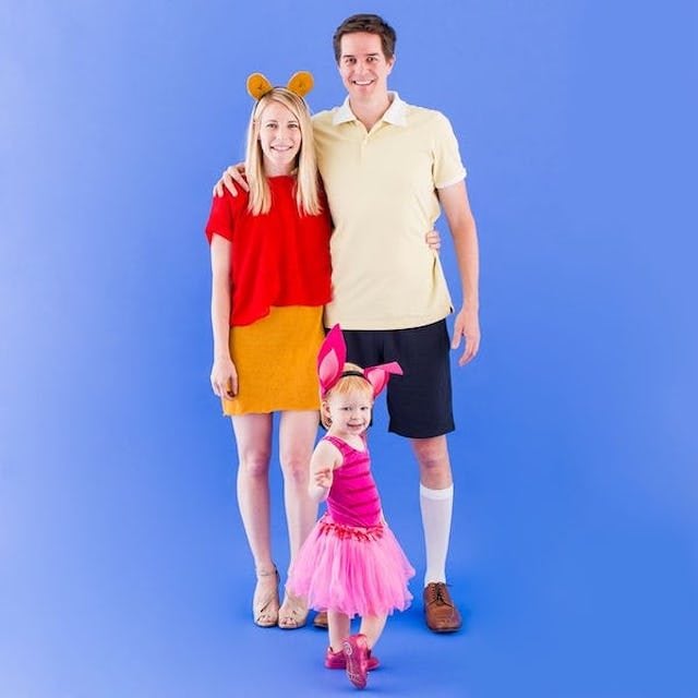 Photo of parents and child dressed as Winnie the Pooh characters for Halloween