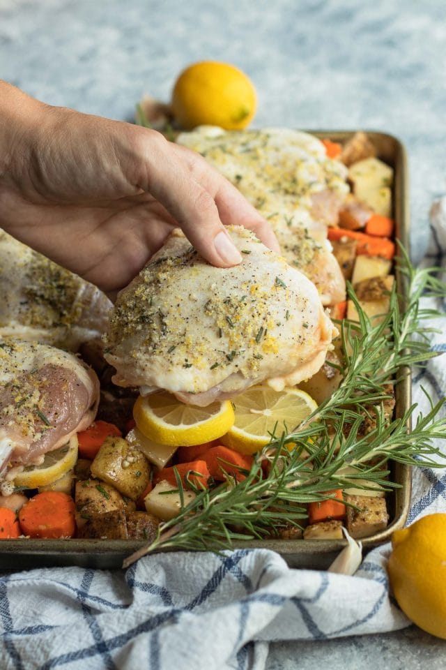 Closeup image of rosemary seasoning for the Lemon Rosemary Chicken Sheet Pan Dinner recipe by top Houston lifestyle blogger Ashley Rose of Sugar & Cloth