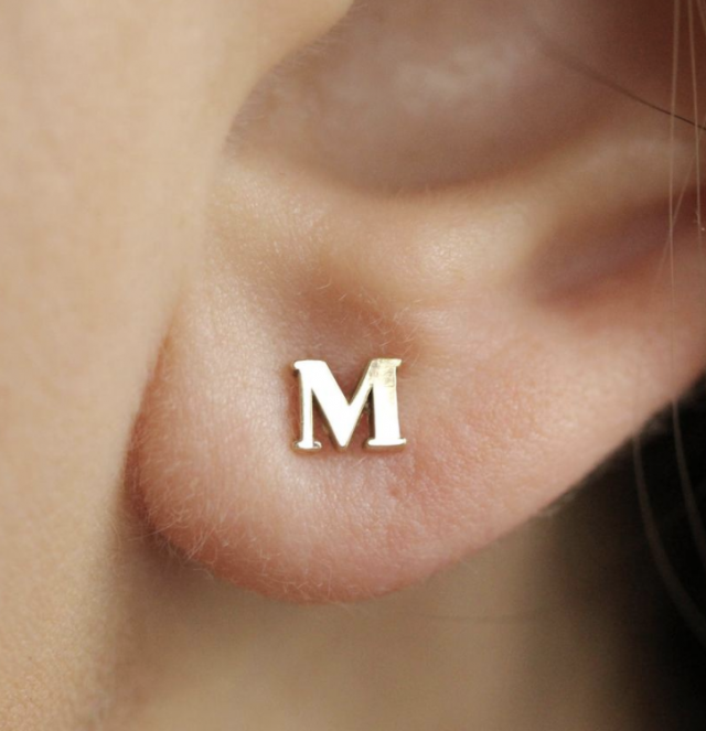 photo of solid gold initial earrings gift on a girls ear