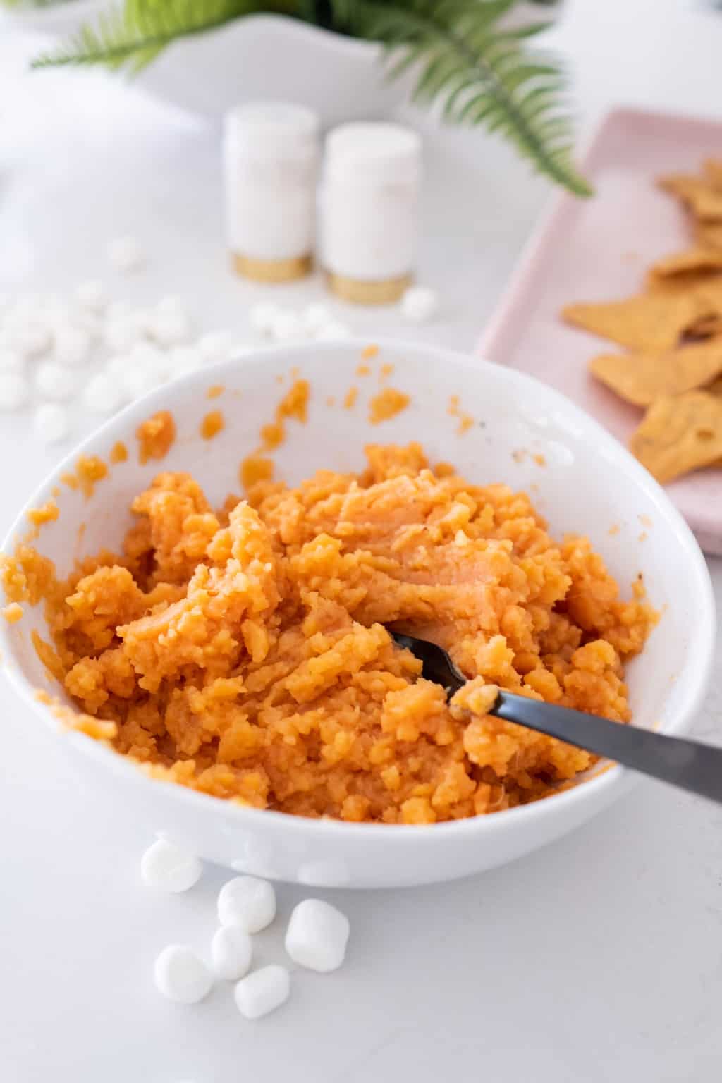 photo of the sweet potatoes being mashed for the Sweet Potato Nachos Recipe by top Houston lifestyle blogger Ashley Rose of Sugar & Cloth