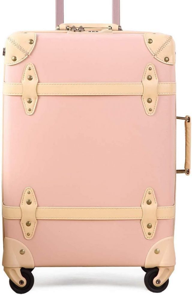 photo of a pink vintage carry on luggage