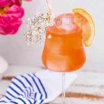photo of the Elderflower Aperol Spritz cocktail recipe garnished with baby breath by top Houston lifestyle blogger Ashley Rose of Sugar & Cloth