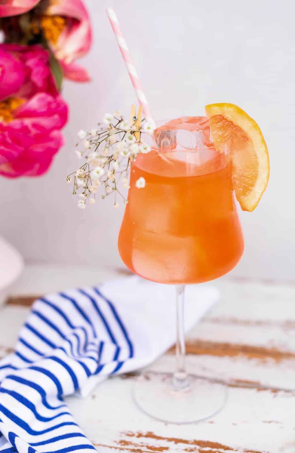 photo of he Elderflower Aperol Spritz cocktail recipe garnished with baby breath by top Houston lifestyle blogger Ashley Rose of Sugar & Cloth