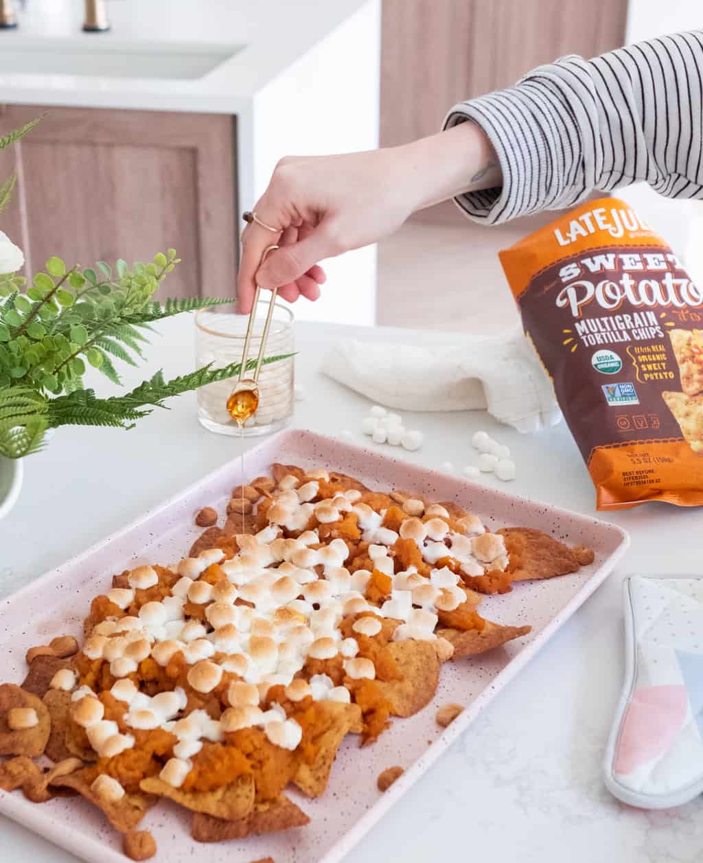 photo of the honey being drizzled on the Sweet Potato Nachos Recipe With Late July Tortilla Chips by top Houston lifestyle blogger Ashley Rose of Sugar & Cloth